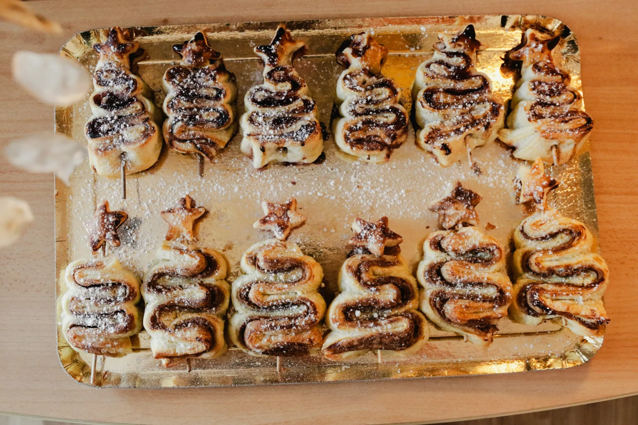 a tray filled with pastries sitting on top of a wooden table